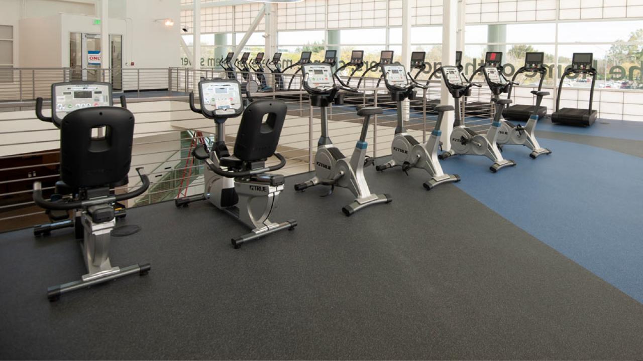 A row of exercise machines on the upper level of the TV Activities and Recreation Center